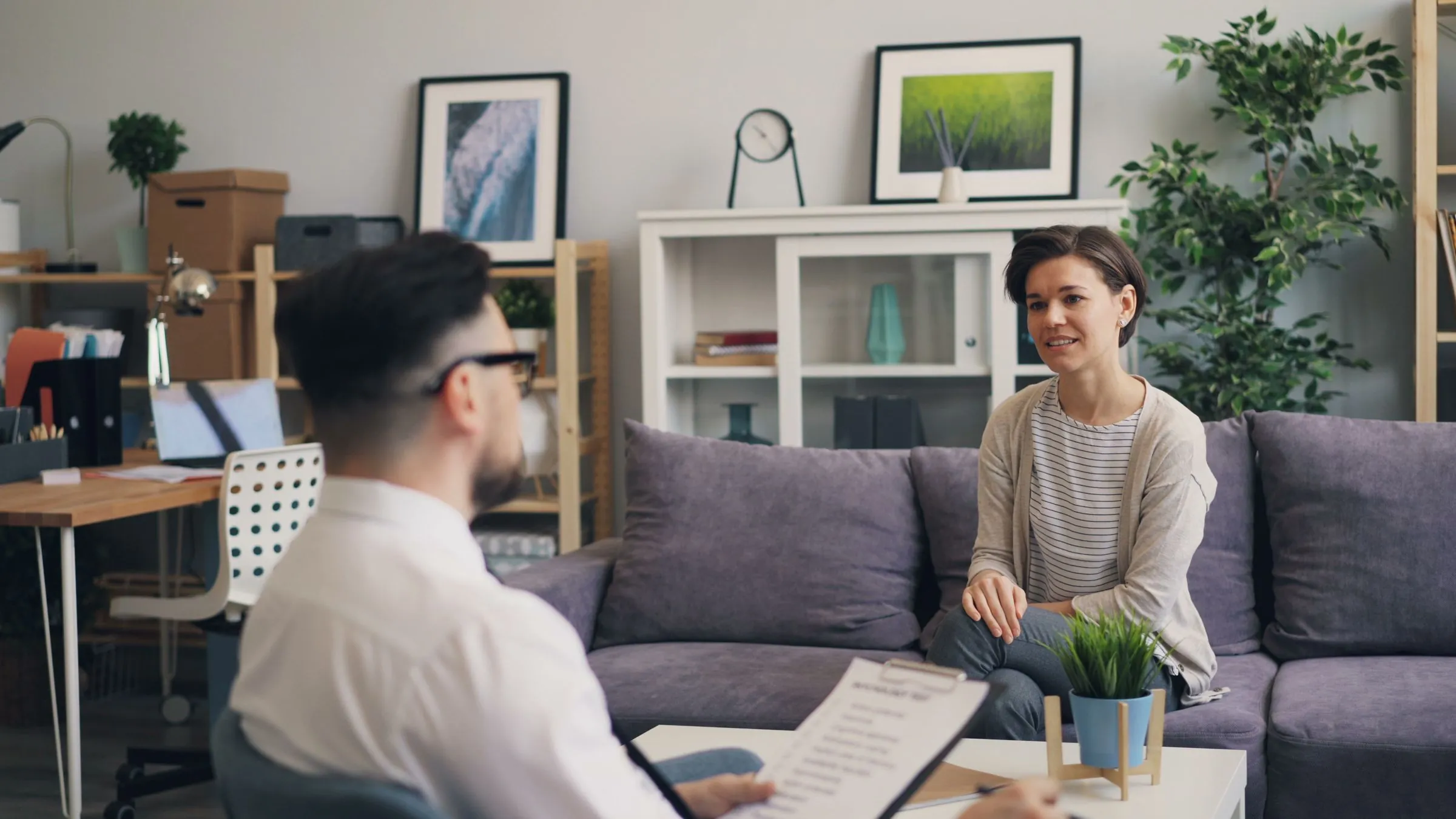 Two people in conversation in a relaxed, light-filled consulting room