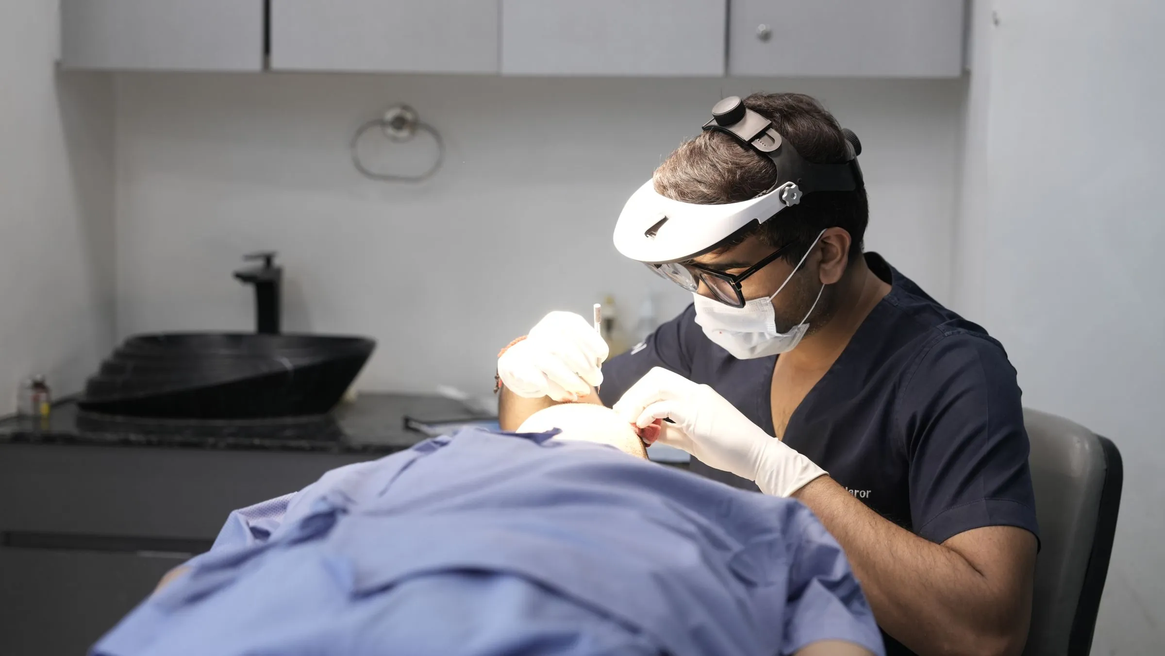 A dermatologist carrying out a skin treatment in a modern clinic