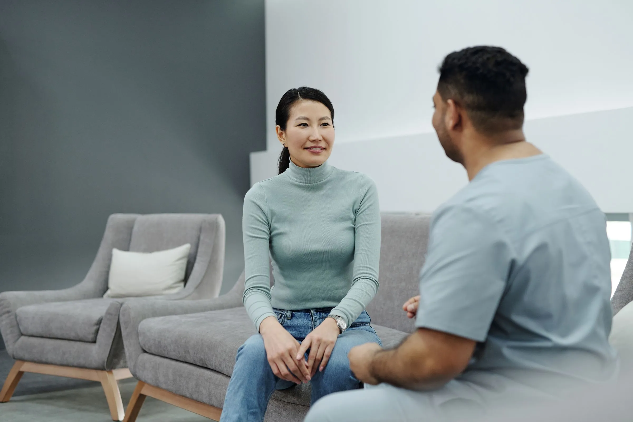 A patient and a clinician talking in a comfortable consulting room