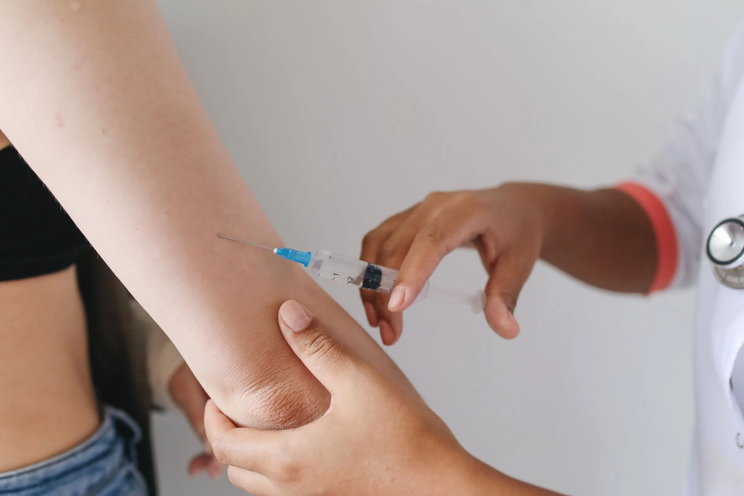 A nurse giving an injection into a patient's upper arm