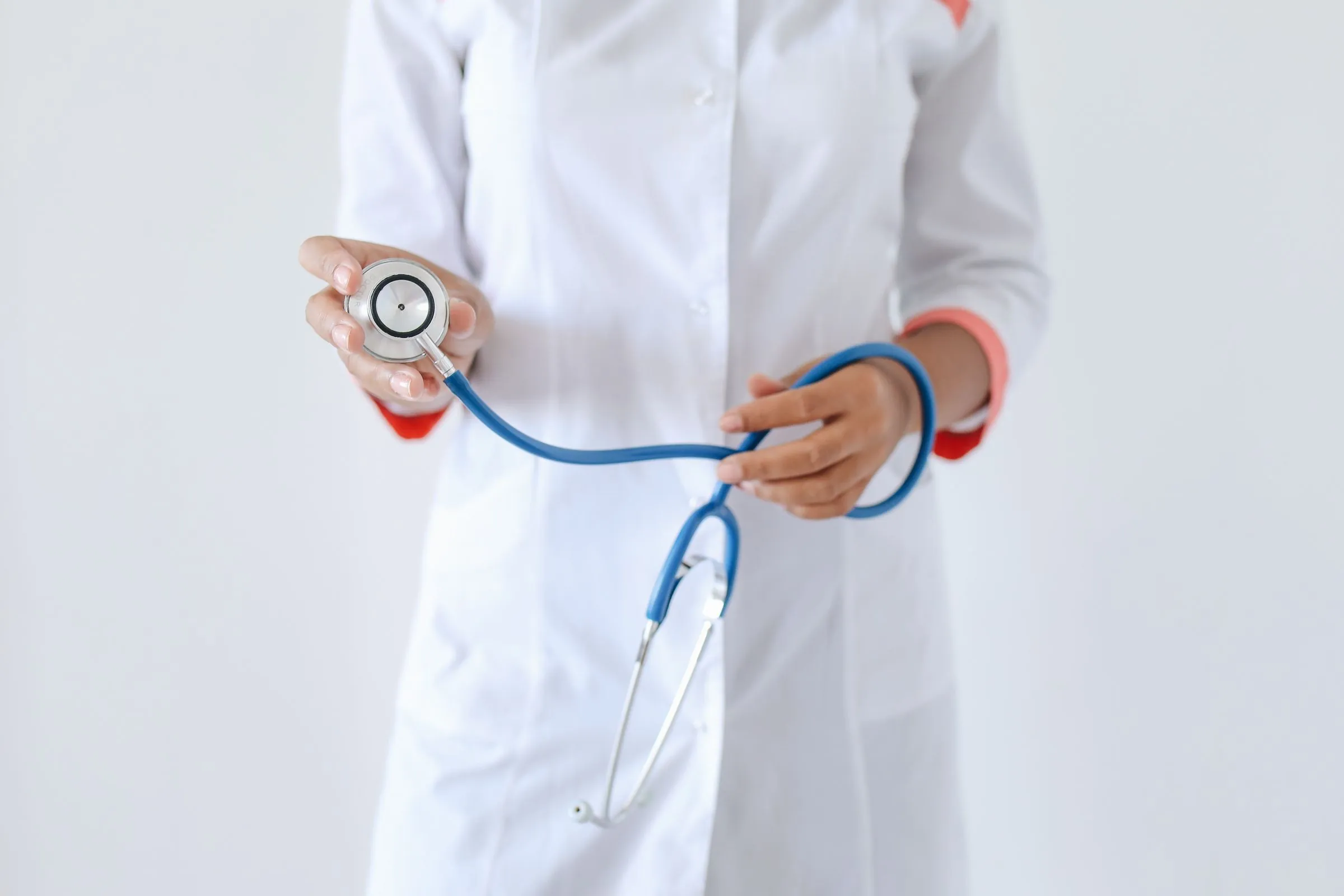 A clinician holding a stethoscope