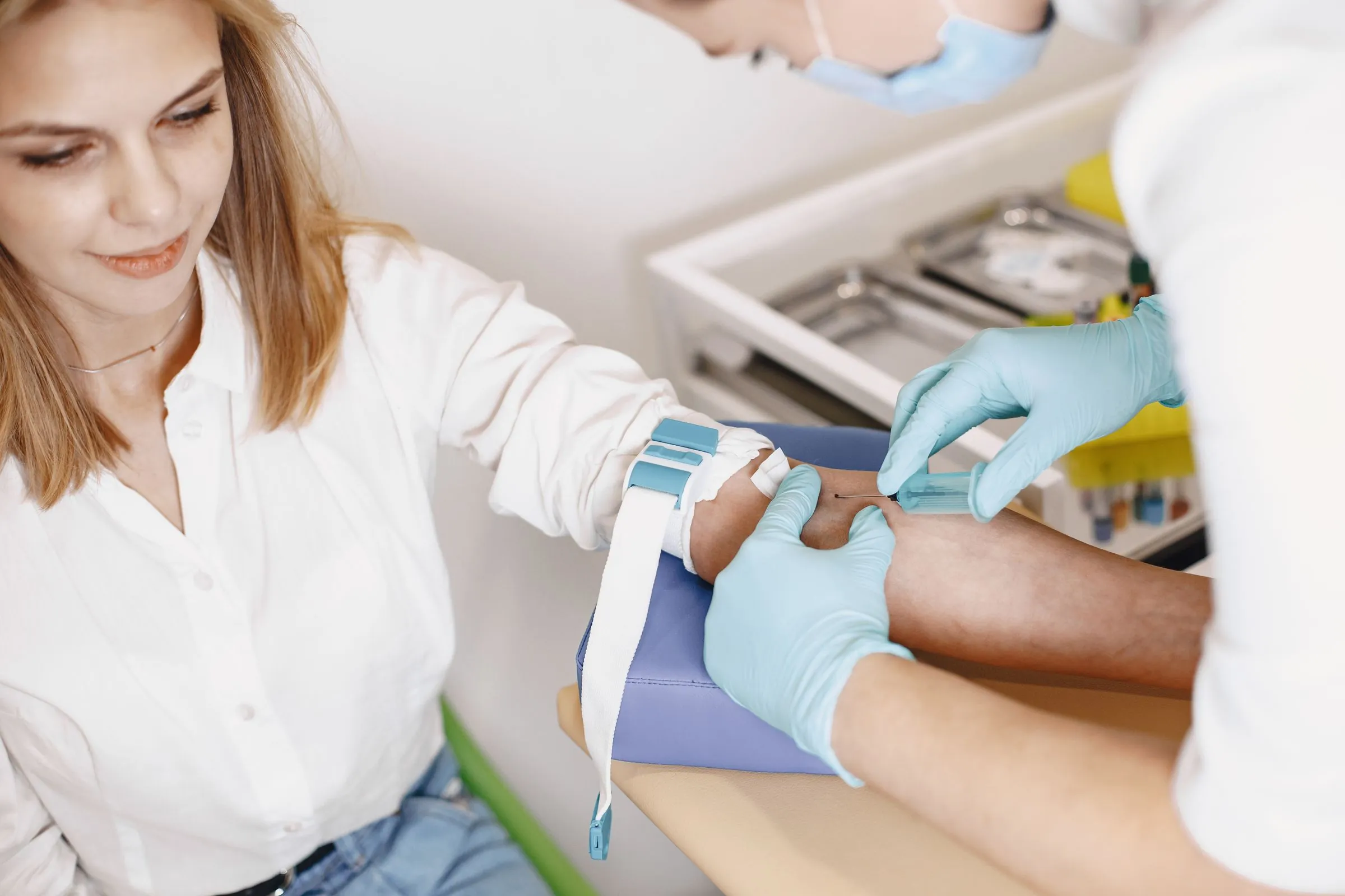 A nurse preparing a patient's arm for a blood test