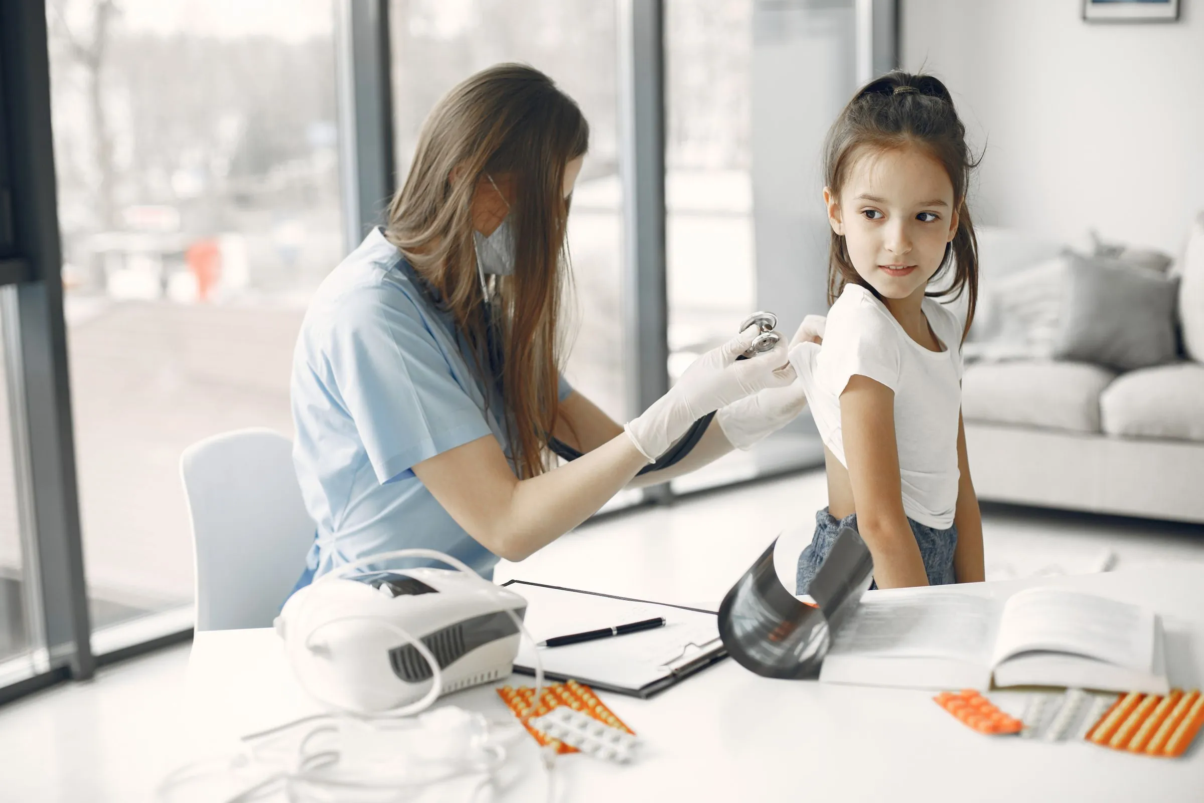 A young girl having a check-up with a doctor in a bright clinic