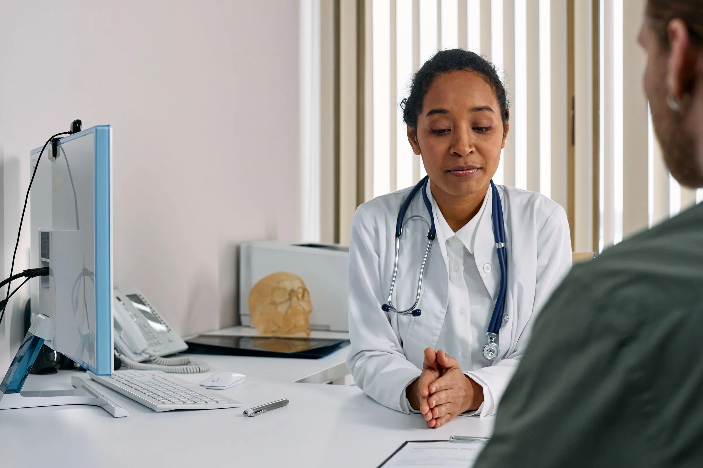 A doctor consulting a patient in a clinic room
