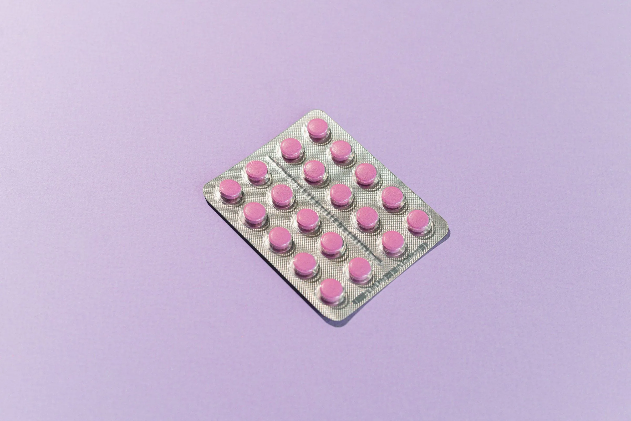 A blister pack of tablets on a plain background